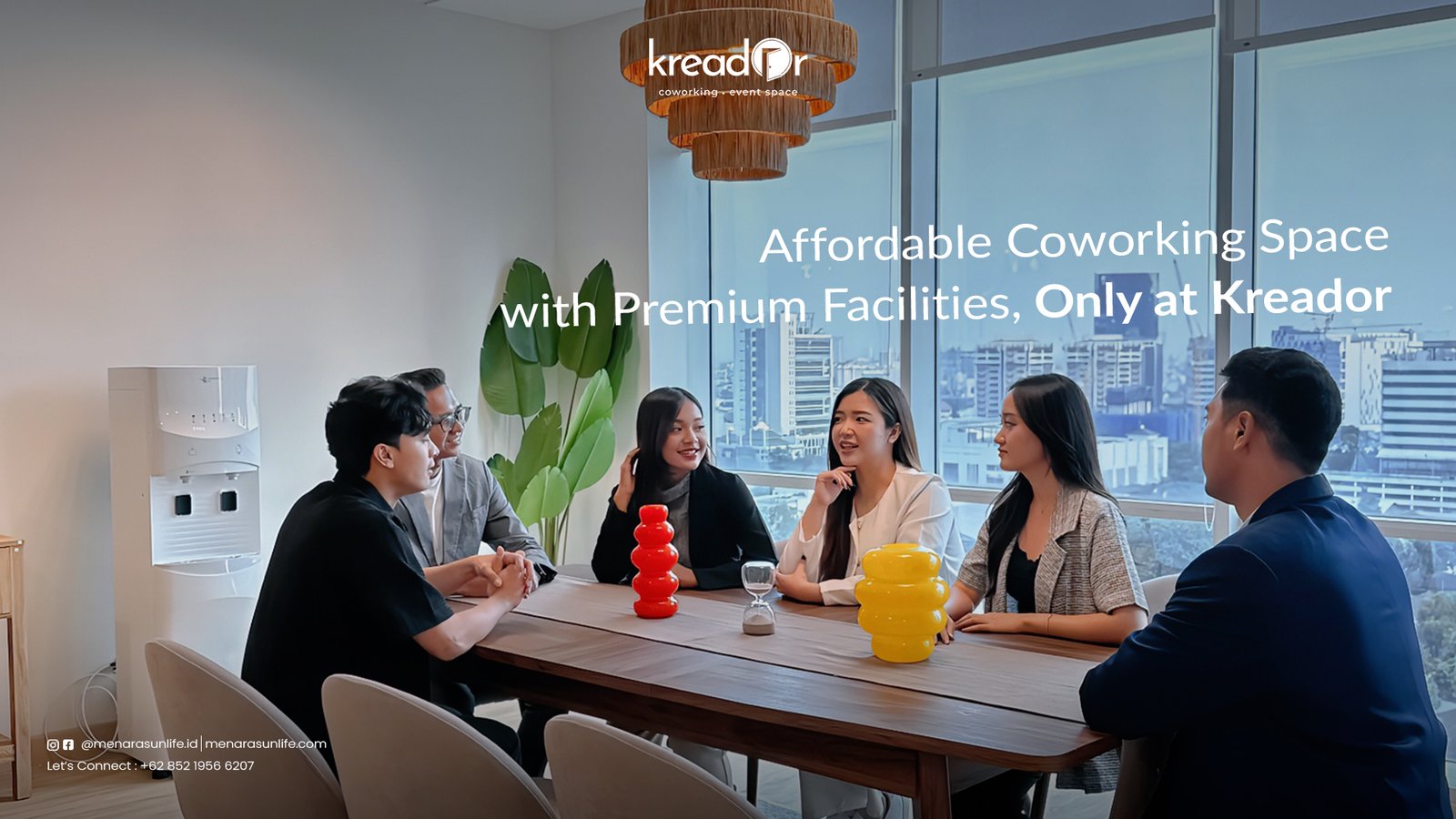 Affordable Coworking Space with Premium Facilities, Only at Kreador A group of professionals in a modern coworking space at Kreador, discussing ideas in a bright, collaborative environment with a city view.